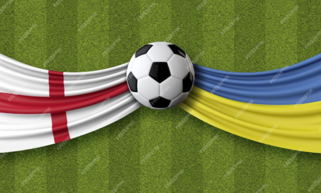 A soccer ball placed between two flag-themed draped fabrics: the flag of England on the left, with a red cross on a white background, and the flag of Ukraine on the right, with blue and yellow horizontal stripes. The scene is set on a green grass field, symbolizing a match between the national football teams of England and Ukraine